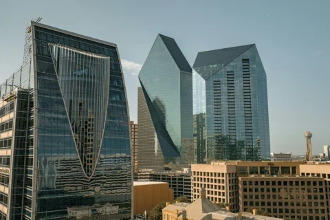 dallas-texas Modern glass skyscrapers in downtown Dallas, Texas, including the iconic Fountain Place and the nearby Reunion Tower.