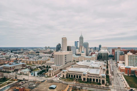 indianapolis-in Aerial view of downtown Indianapolis, Indiana with the Indiana Statehouse and city buildings on a cloudy day.