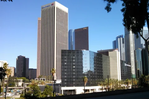 los-angeles-ca Downtown Los Angeles skyline with tall office buildings including Bank of America and KPMG Tower on a sunny day.