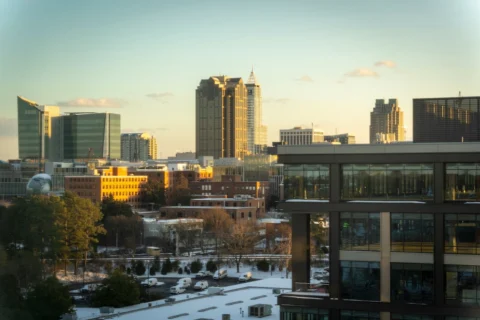 raleigh-nc Skyline of Raleigh, North Carolina at sunset with modern office towers and NC State government buildings.