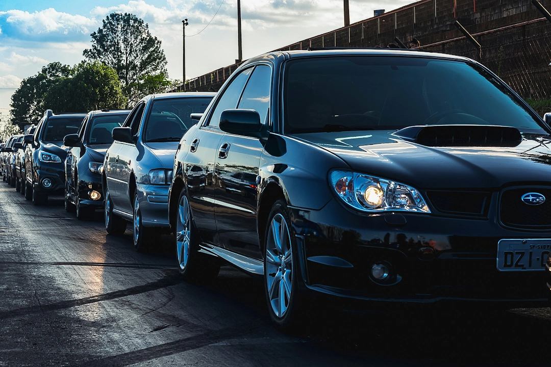 automotive-and-transportation A line of parked cars on a road under a blue sky, symbolizing automotive and transportation services
